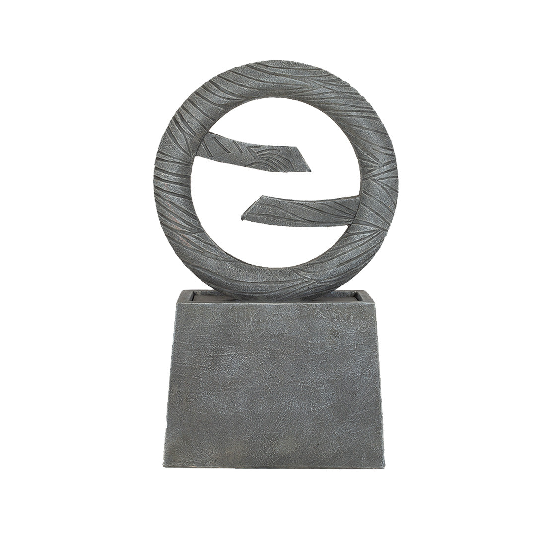 The Jackson Spills sculpture by La Hacienda features an abstract gray leaf design with two protruding segments, mounted on a square base. Its textured finish and minimalistic, modern aesthetic make it perfect for creating a garden oasis.