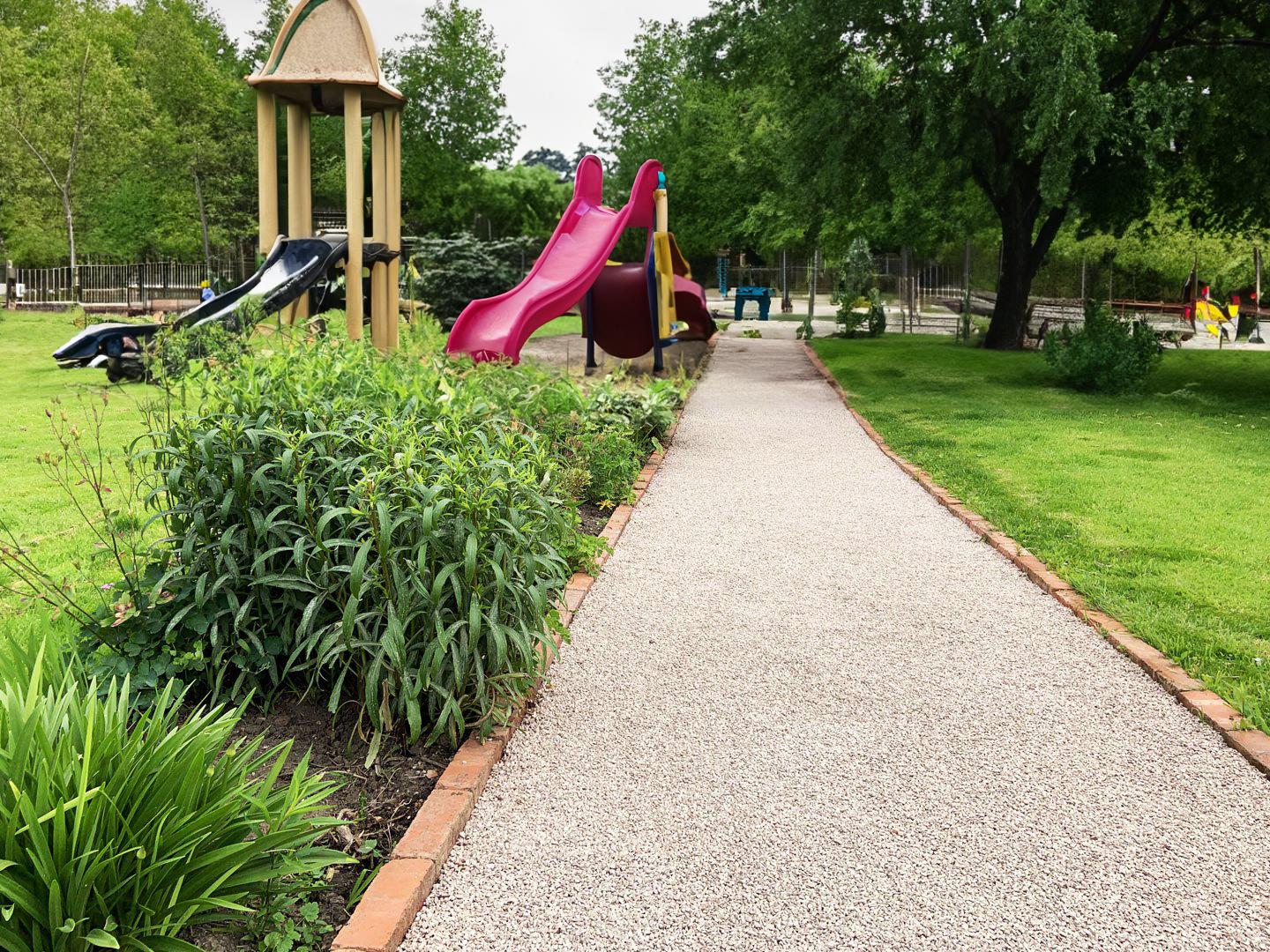a playground with a slide in the middle of it