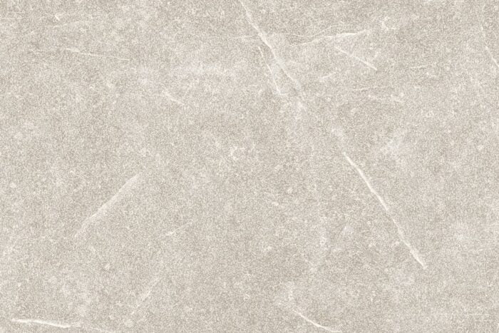 A close-up view of a gray stone surface with subtle white veins and a textured appearance, ideal for enhancing outdoor spaces. This slip-resistant surface embodies the elegance of Maestrat Perla Porcelain Paving by Brisks.