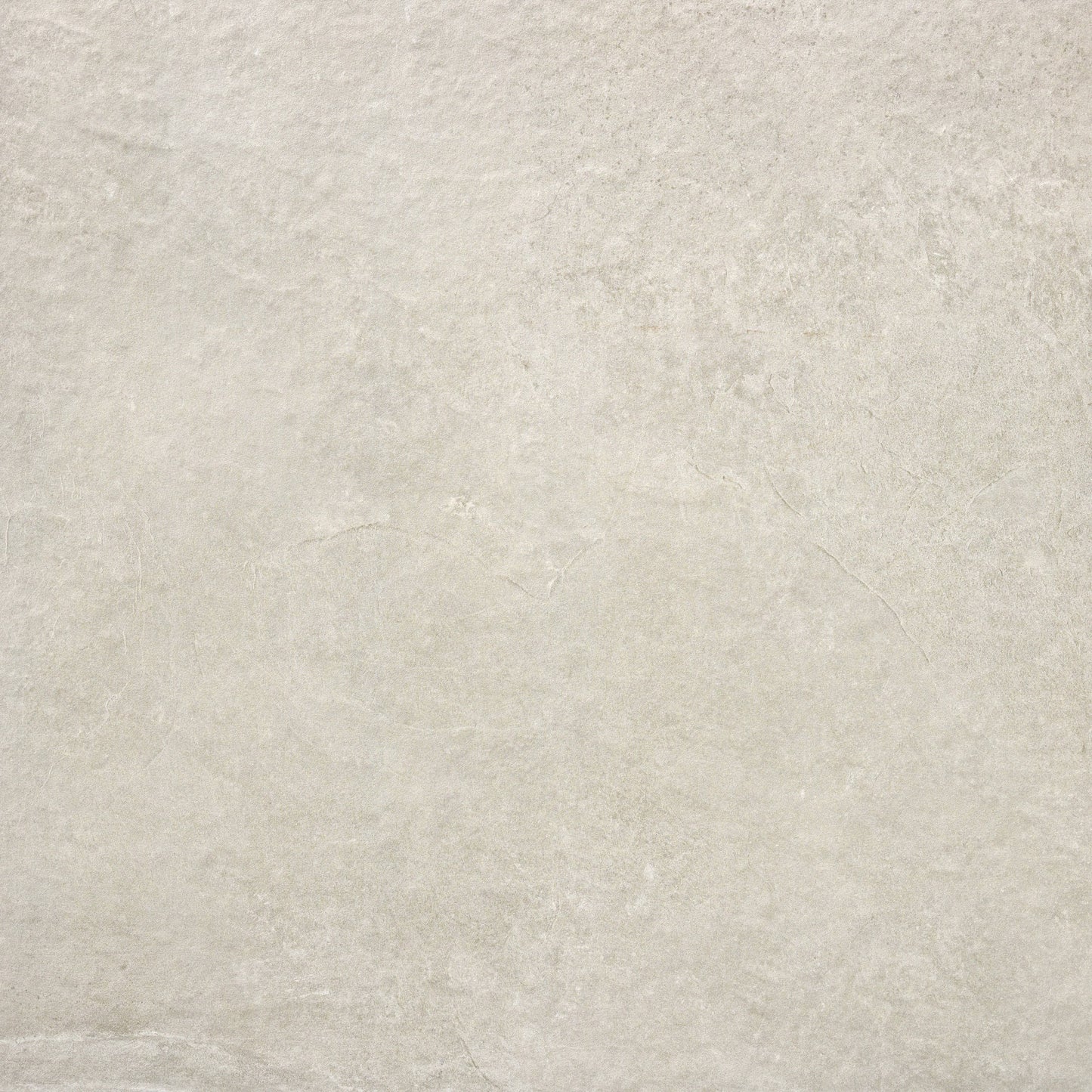 A close-up of a light beige stone texture, resembling Brisks' Priorat Bone Porcelain Paving, showcases subtle natural patterns and variations in tone. The surface appears smooth yet slip-resistant, with slight irregularities that evoke understated elegance and organic simplicity.