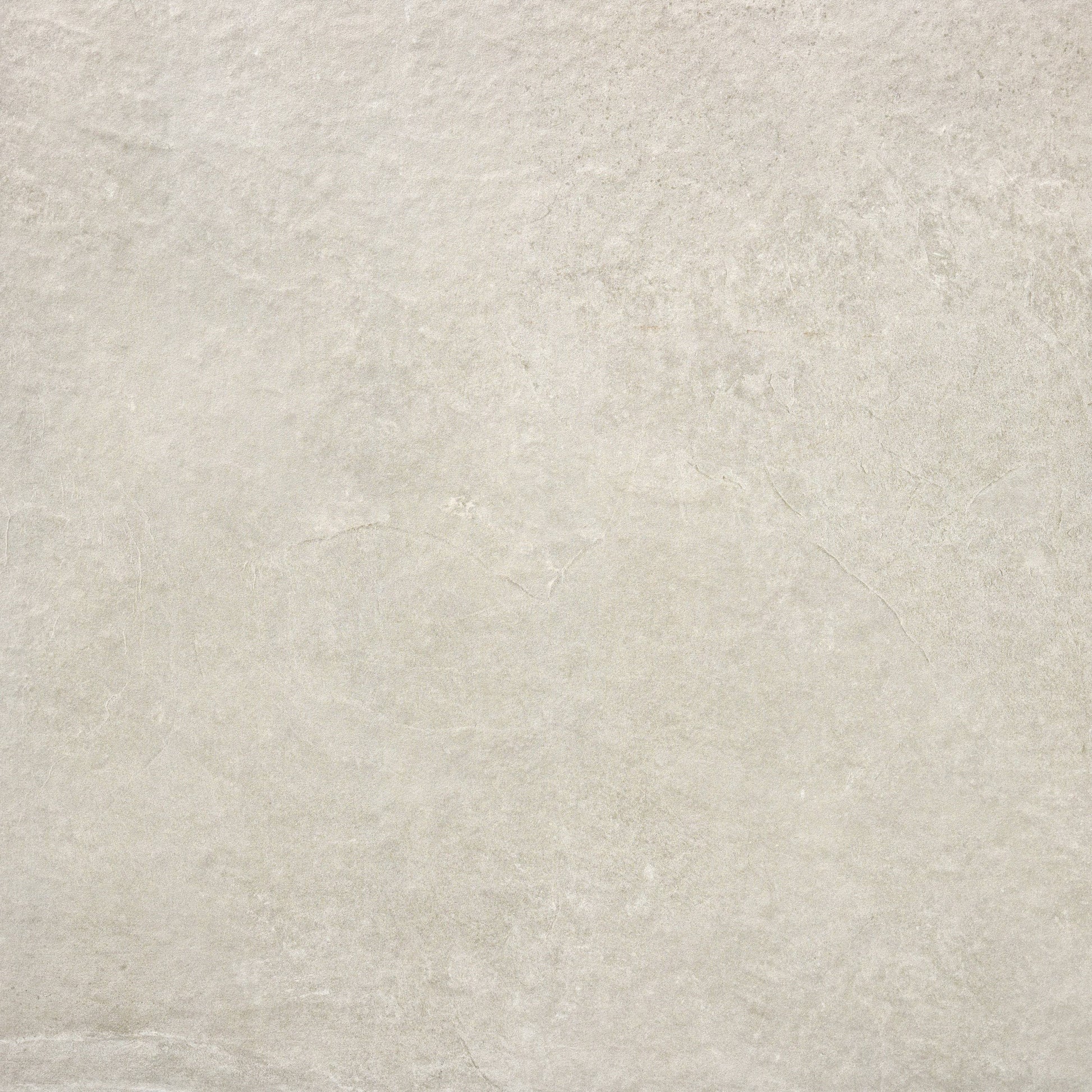 A close-up of a light beige stone texture, resembling Brisks' Priorat Bone Porcelain Paving, showcases subtle natural patterns and variations in tone. The surface appears smooth yet slip-resistant, with slight irregularities that evoke understated elegance and organic simplicity.