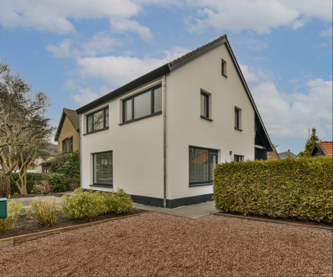 a white house with a black roof and windows