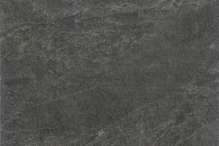 A close-up image of a dark gray textured slate surface. The texture appears slightly rough with variations in shading and subtle streaks and veins throughout the stone, reminiscent of high-quality Brisks Frame Groove Porcelain Paving Slabs.
