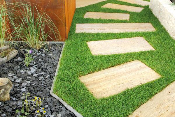 a stone path with grass growing on top of it