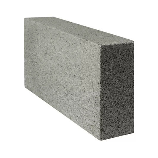 A gray, rectangular Brisks 100mm Solid Dense 7.3N Block with a rough texture is slightly tilted to the left against a white background. Its top, side, and front surfaces are visible, highlighting its reliable strength—a cost-effective choice for construction projects.