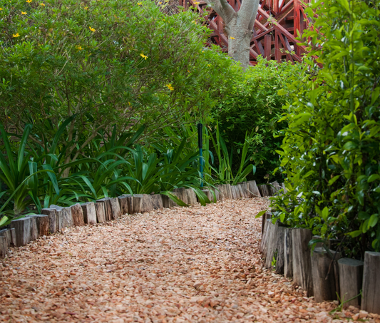 a wooden bench sitting in the middle of a garden