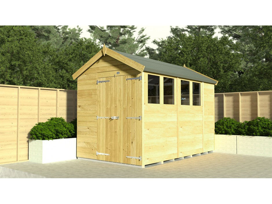 The ShedsDIY Apex Shed 4ft Wide is a wooden garden shed with a green sloped roof, metal-hinged door, and multiple small windows. Weather-resistant, it sits on paved ground, encircled by wooden fencing and lush planters, offering excellent garden storage.