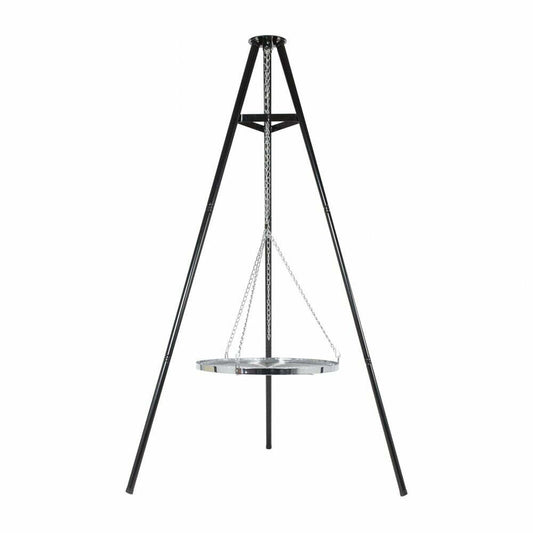 The La Hacienda Tripod Hanging Grill features a black metal tripod supporting a circular chrome-plated cooking surface suspended by chains. This design is perfect for outdoor cooking, allowing the grill to be positioned above the ground for use over a fire, with the black tripod elegantly complementing the silver finish of the grill.