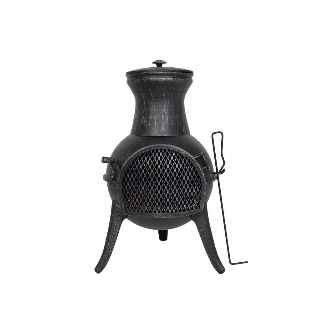 The La Hacienda Squat Chimenea, from the renowned brand La Hacienda, is an elegant patio heater crafted from metal. This small, black chiminea boasts a bulbous base and a narrow chimney, standing securely on three legs. It features a mesh front opening designed for safe wood-fired warmth management and includes a handy poking tool resting beside it. The backdrop is a simple plain white.