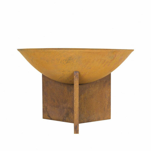 The La Hacienda Kala Firepit features a rusty, round cast iron bowl with a wide brim set on a square, rustic metal base. The oxidized bowl boasts an aged, weathered look, complemented by the base’s simple geometric design. The background is plain white.