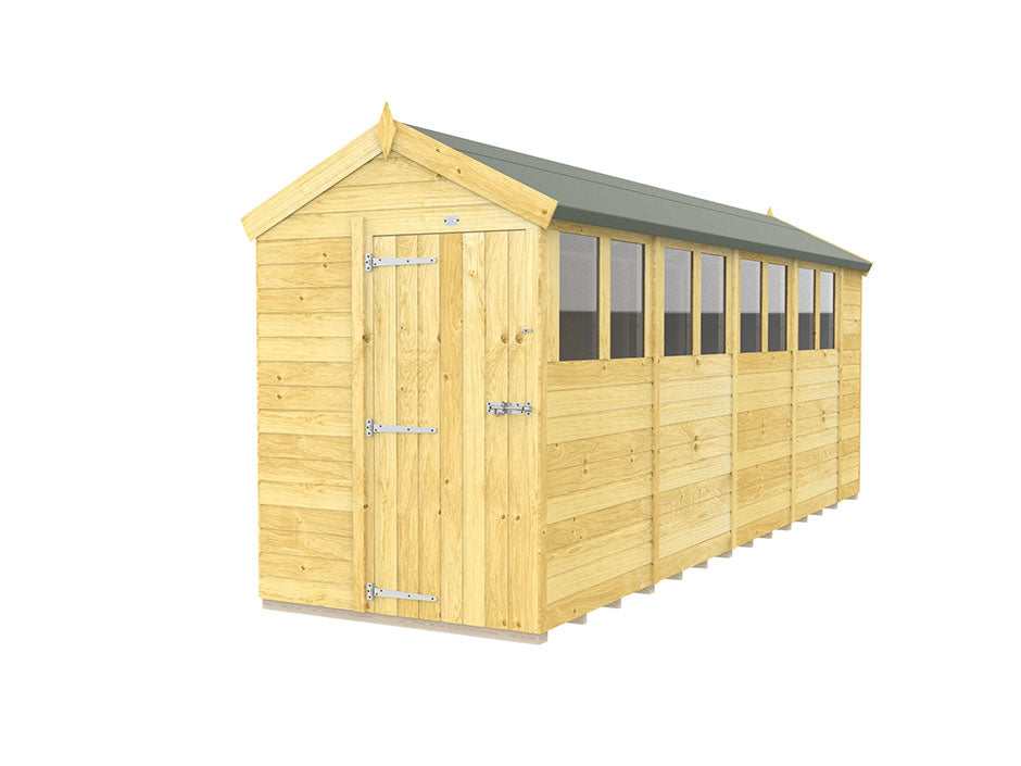 The ShedsDIY Apex Shed 5ft Wide proudly sits in the garden with its tongue and groove construction and green roof. It has a single door with metal hinges, a row of side windows, and showcases a light, natural wood finish.