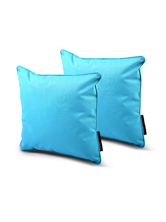 Two bright blue throw pillows with black tags are positioned against a plain white background. These Brisks B Cushion Twin Pack Brights Collection cushions are simple in design with a soft and smooth texture, adding a pop of color to any interior space.