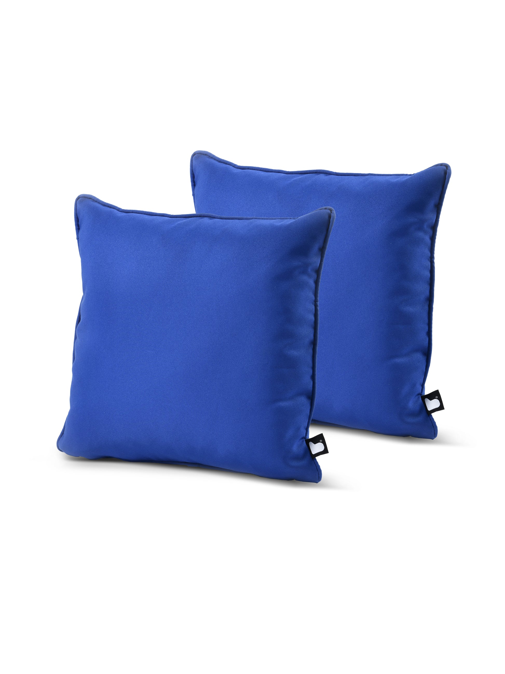 Two blue "B Cushion Twin Pack Brights Collection" pillows by Brisks with a smooth, satin-like finish, made of breathable polyester. The pillow on the left is positioned slightly forward, with the second pillow behind it, partially visible. Both pillows have a small black tag on one side. The white background highlights the pillows.