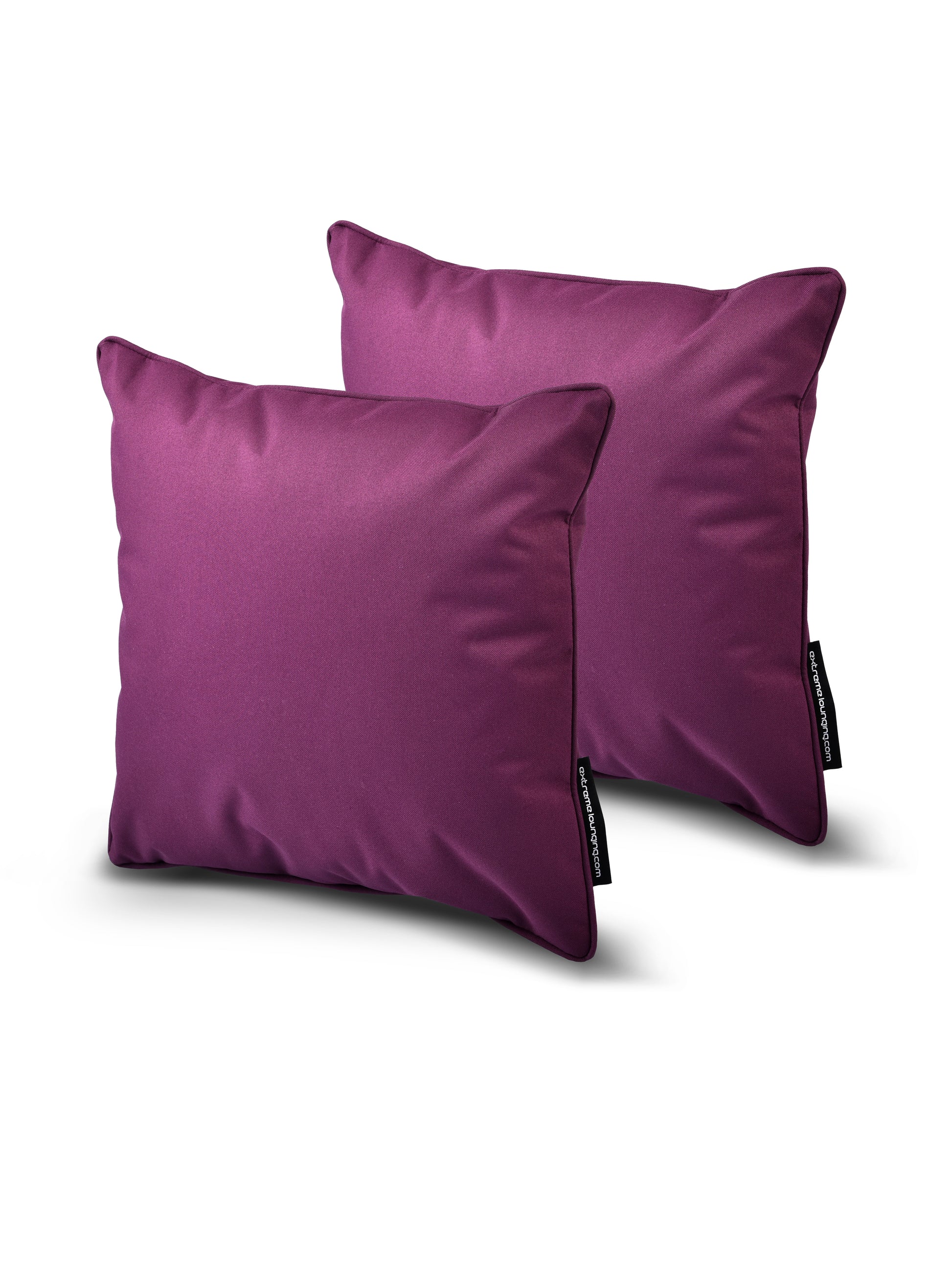 Two vibrant purple square pillows from the B Cushion Twin Pack Brights Collection by Brisks are placed against a white background. Each pillow, made from breathable polyester, has a smooth texture with a tag on the side that features text. The UV-resistant pillows look soft and plush, perfect for use on a sofa or bed.