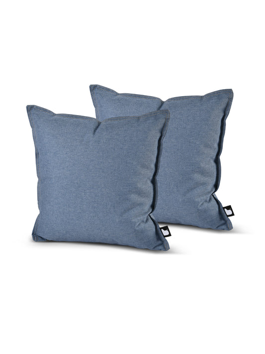 Two blue Brisks B Cushion Twin Pack Denim Collection throw pillows are placed side by side against a white background. The pillows have a simple design with slightly tapered corners and visible stitching along the edges. Each pillow, made from splash-proof fabric, features a small black tag on the side.