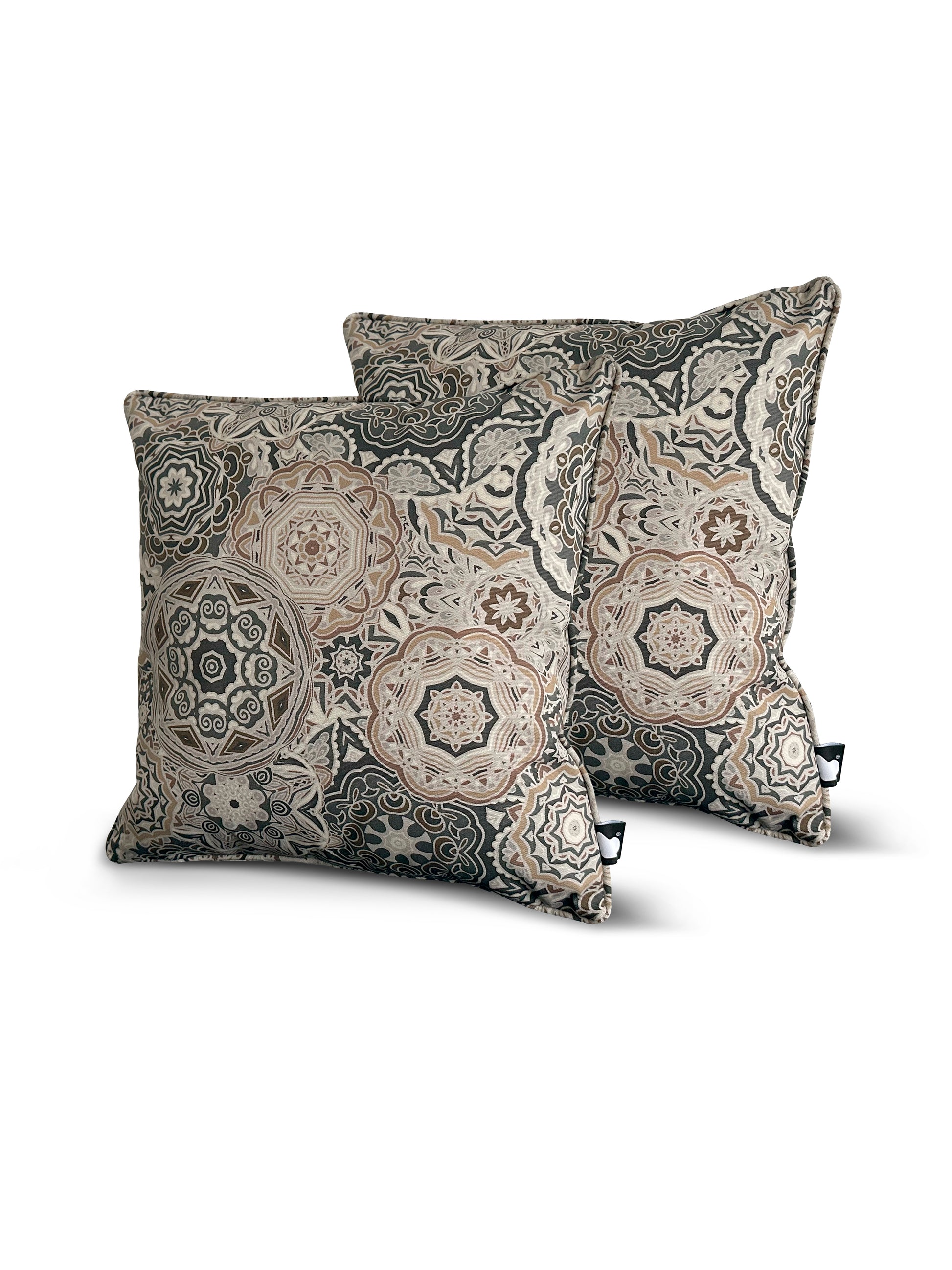 Two decorative Brisks B Cushion Twin Pack Art Collection with intricate geometric and floral patterns in shades of beige, cream, and dark blue. The design features motifs reminiscent of mandalas and traditional tile work. These UV-resistant pillows are placed at a slight angle, leaning against each other.