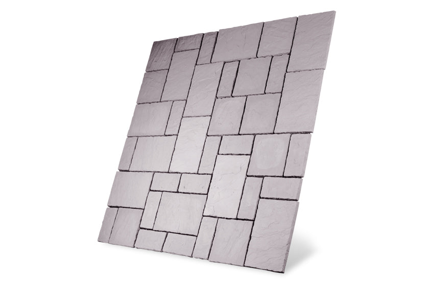 An image featuring a square tile arrangement with various geometric patterns. The tiles, part of the Weathered Moss Cathedral Paving Kit by Bowland Stone from the Brisks brand, resemble Cathedral Paving or sandstone paving slabs and come in different sizes. This creates a mosaic effect with a mix of rectangles and squares. The surface has a textured, stone-like appearance set against a white background.