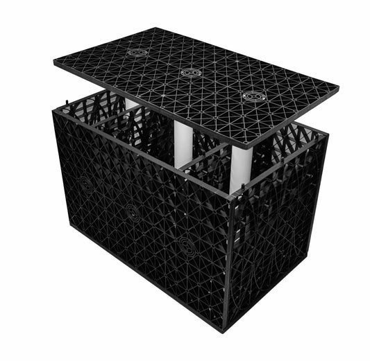 The CORE WATER Soakaway Crate by Core LP is a black modular storage container with an open grid design and interior compartments ideal for rainwater management. It has a removable lid and three vertical white tubes, which enhance its efficient drainage technology.