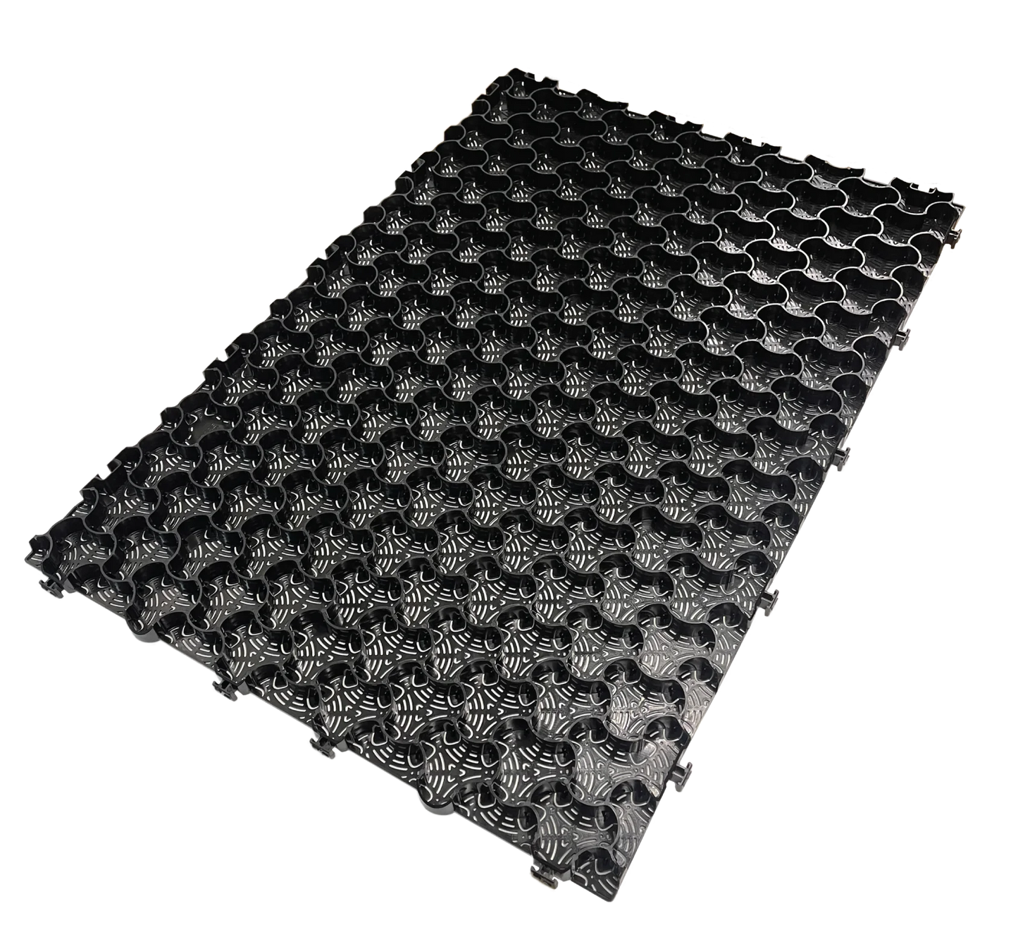 The CORE COMMERCIAL 75-30 - Gravel Grid by Core LP is a black, rectangular interlocking mat with a floral grid pattern that enhances gravel stabilization. Its textured, raised surface offers a uniform, decorative look ideal for managing commercial traffic and is displayed on a white background.