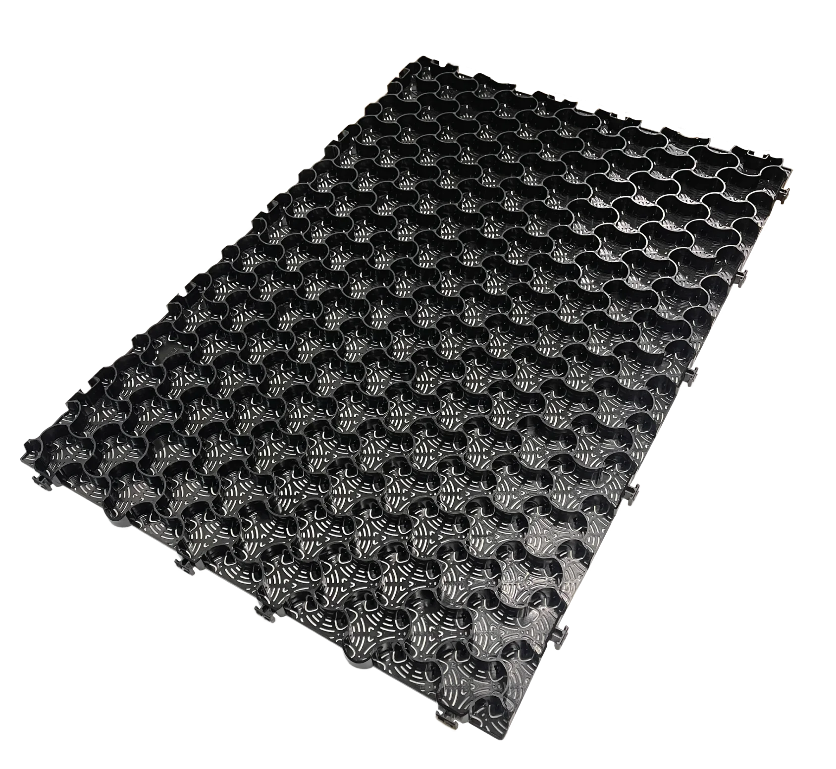 The CORE COMMERCIAL 75-30 - Gravel Grid by Core LP is a black, rectangular interlocking mat with a floral grid pattern that enhances gravel stabilization. Its textured, raised surface offers a uniform, decorative look ideal for managing commercial traffic and is displayed on a white background.