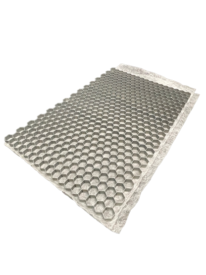 The CORE DRIVE 40-30 / 40-40 - Gravel Grid by Core LP is a rectangular sheet with a 3D honeycomb hexagonal structure for gravel stabilization. One end is partially elevated for a perspective view, and the edges form a contrasting flat band.