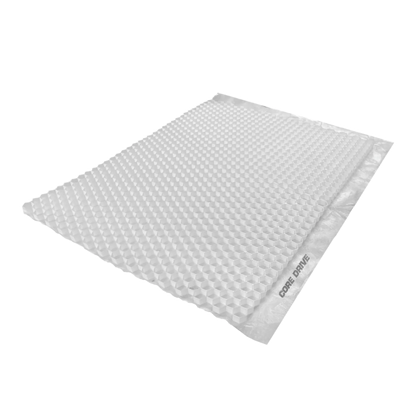 A light gray, rectangular bubble mailer with a textured surface is seen at an angle, reminiscent of porous geotextile. A strip on the side is labeled "CORE DRIVE 40-30 / 40-40 - Gravel Grid" from Core LP.