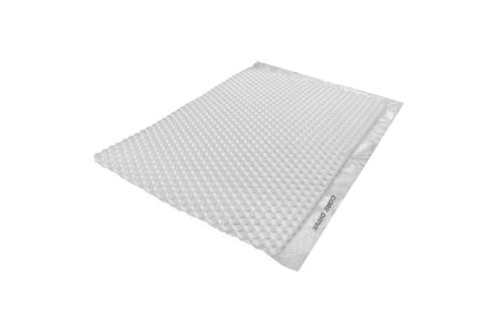 A CORE DRIVE 40-30 / 40-40 Gravel Grid by Core LP is viewed from an angle, resembling a rectangular white padded mailing envelope with textured bubble wrap. Its sealing strip along the top edge suggests sustainable materials and promotes eco-friendly packaging solutions.