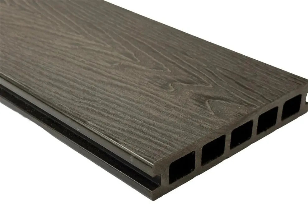 Close-up of Deck&Grass's Woodgrain Composite Decking Board, featuring a dark brown hue, textured wood-grain finish, and multi-chamber hollow design for low-maintenance use in outdoor living spaces.