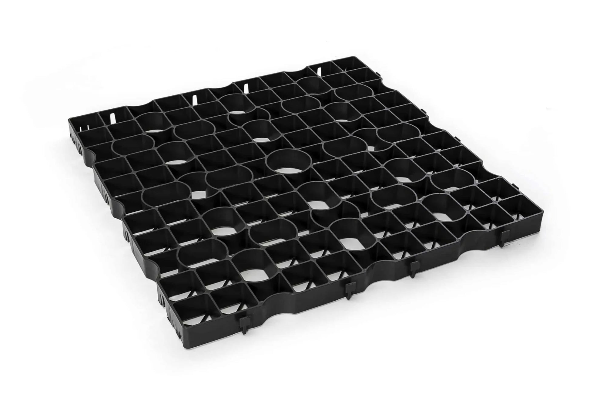 Against a plain white background, the CORE GRASS 40 panel by Core LP is showcased. Made from recycled high-density polyethylene (HDPE), it features a black plastic grid design with a square pattern, interlocking edges, and circular cutouts in each section to ensure efficient drainage facilitation for light commercial traffic grass reinforcement.