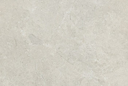 The Brisks Next Marfil Porcelain Paving tiles boast an elegant design with a textured light gray stone surface. Their subtle color variations and delicate natural veins enhance their beauty, while their exceptional durability ensures long-lasting performance, closely resembling premium stone or concrete materials.