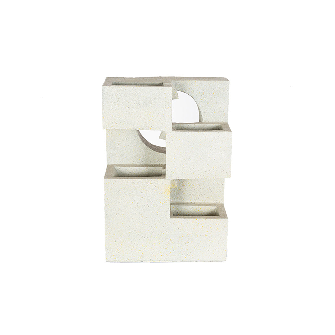 La Hacienda presents "Cube Falls," an abstract concrete-effect sculpture featuring geometric shapes like rectangular blocks with cutouts and a circular hole in the center. This minimalist piece stands vertically on a white background, evoking the sleek aesthetics of modern design.