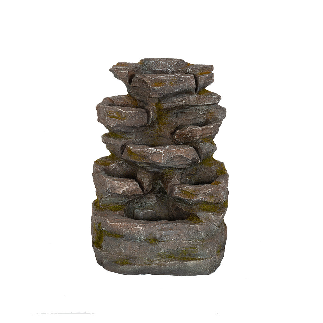 Introducing the Rock Falls by La Hacienda: a garden water fountain designed with a tiered stone aesthetic. It features multiple cascading levels that create a naturalistic appearance, enhanced by moss accents on its surface for added earthy charm. Set against a plain white background, this waterfall feature is perfect for adding tranquility and elegance to any outdoor space.