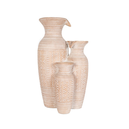 A trio of La Hacienda's Aztec Vases, each uniquely sized, showcases geometric patterns reminiscent of Aztec designs with a textured finish. These vases feature intricate lines and motifs that beautifully complement any garden oasis.