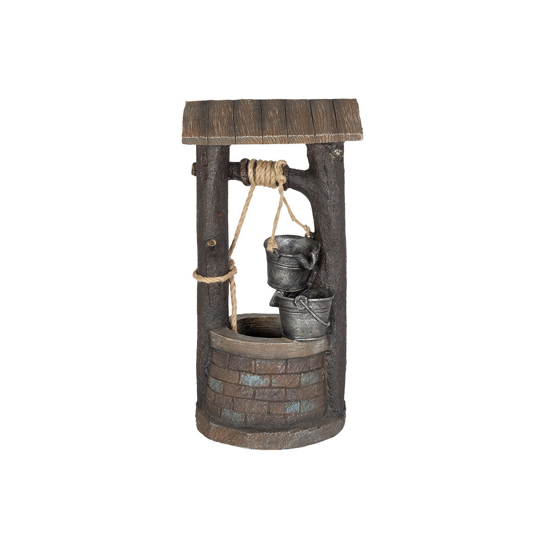 The La Hacienda "Wishing Well incl LEDs" features a rustic design with a roof, rope, and metal bucket, set against a plain white backdrop. Its stone-like base enhances its charm, making it an ideal garden decoration that adds timeless appeal to any outdoor space.