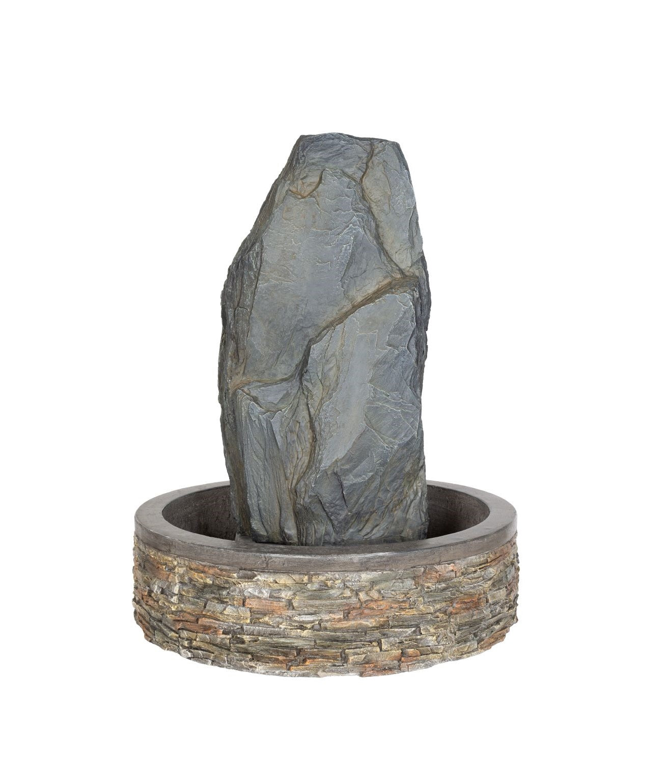 A large, rugged stone sculpture from La Hacienda, known as the Snowdonia Monolith, stands upright in the center of a circular stone-bordered base. This natural stone features textures and shades of gray and brown, resembling an ancient monument set against a plain white backdrop.