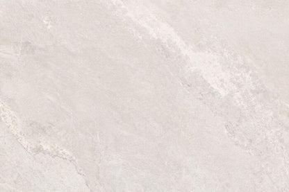 A close-up of a beige stone surface mimics the refined look of Agra White Porcelain Paving from Brisks, featuring subtle texture and color variations. Its smooth, matte finish offers slip resistance, making it ideal for naturally and elegantly enhancing outdoor spaces.