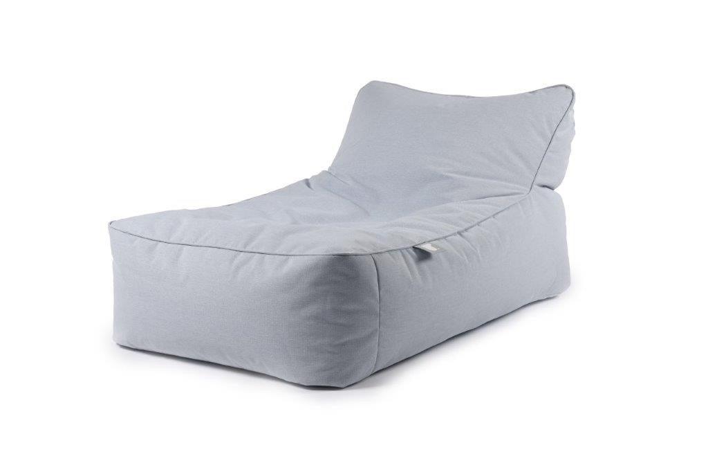 A light gray, fabric-covered Brisks Extreme Lounging B-Bed Pastel with an extended backrest for added support. The chair is cushioned and has a soft, inviting appearance, suitable for lounging. The background is plain and white, emphasizing the chair's smooth texture and modern design.