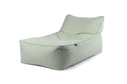 A light green, cushioned bean bag chair with an extended, reclined backrest is shown against a white background. Ideal for a garden retreat, the chair has a modern, minimalist design and appears to be made of soft fabric. Enjoy extreme lounging on the Brisks Extreme Lounging B-Bed Pastel outdoor lounger.