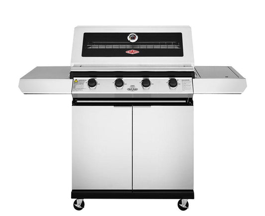 A Brisks BeefEater 1200S Series 4 Burner BBQ & Trolley with three control knobs positioned on a front panel below a temperature gauge. Perfect for enhancing your outdoor living space, the grill features side shelves on both sides and has two cabinet doors at the bottom. Four wheels provide added mobility and modern appeal.