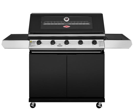 The Brisks BeefEater 1200E Series 5 Burner BBQ & Trolley offers an exceptional outdoor living experience. With four control knobs, a large grilling surface with a lid, and a temperature gauge on the front, this BBQ also features side shelves for extra workspace and is mounted on a wheeled cart for mobility.