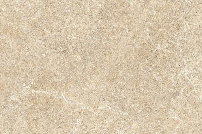 A close-up view of Brisks Carmen Beige Porcelain Paving Slabs reveals a beige marble surface with subtle variations in texture and patterns, featuring light veins and specks throughout. The overall impression is of a smooth and elegant stone, perfect for weatherproofing outdoor spaces like patios or walkways.
