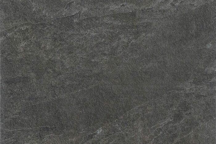 A close-up image of a dark gray textured slate surface. The texture appears slightly rough with variations in shading and subtle streaks and veins throughout the stone, reminiscent of high-quality Brisks Frame Groove Porcelain Paving Slabs.