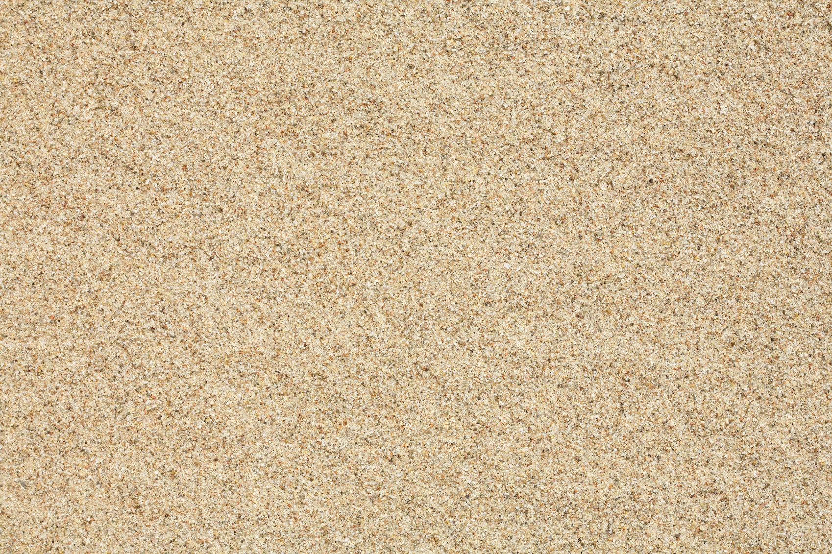A close-up view of fine, light brown sand grains, uniformly spread across the image. The texture appears soft and slightly speckled, with a natural, earthy tone. Ideal for golf course bunker sand due to its even surface and superior non-staining property. Brisks Golf Course Bunker Sand is the perfect choice for maintaining your golf course's pristine bunkers.