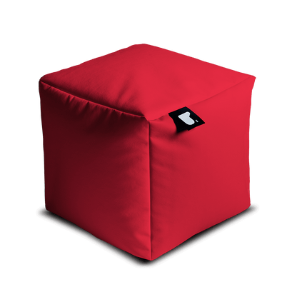 A bright red, fabric-covered cube bean bag filled with polystyrene beads, featuring slightly rounded edges and a small black tag attached to one corner. The tag showcases a white design. This Brisks Extreme Lounging Outdoor B-Box is set against a plain, light grey background, perfect for any garden retreat.