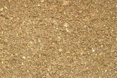 Close-up image of a rough, grainy surface with varying shades of brown and golden buff hues. The texture appears irregular with small, fragmented particles, possibly resembling Brisks Self Binding Path Gravel. The overall appearance is dry and earthy, perfect for weed prevention.